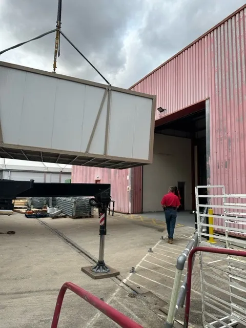 A Tundra pod being lifted off a delivery lorry at a customer site