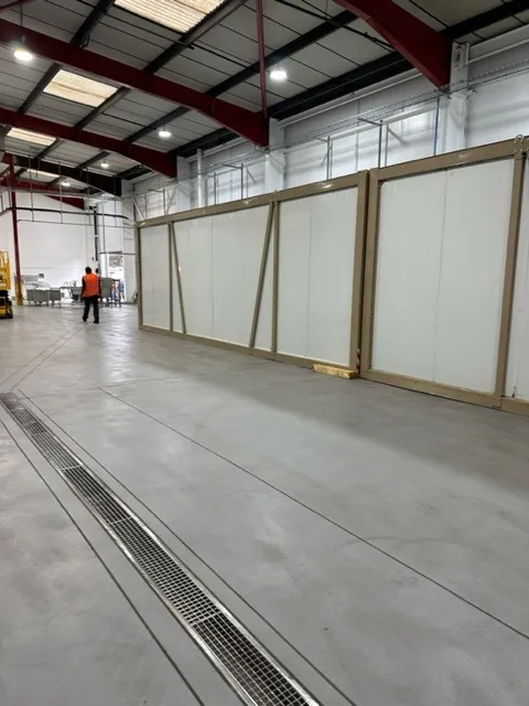 A row of linked Tundra pods installed inside a warehouse