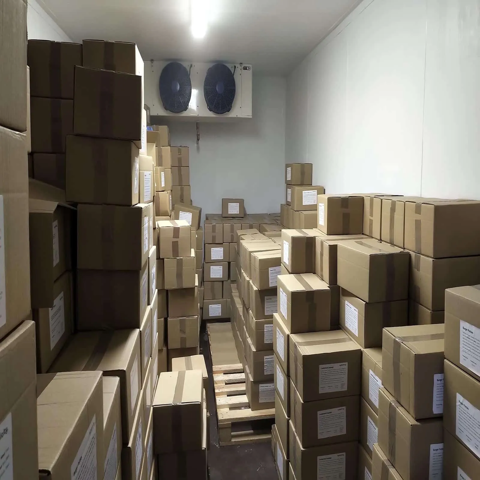 Inside a Tundra cold store stacked with boxed stock on pallets